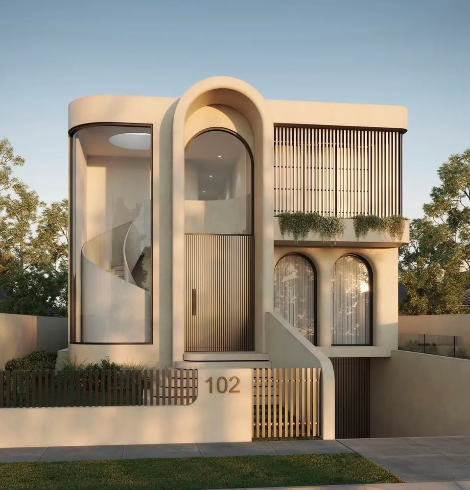 Front view of a narrow two-story residence with arched openings, a glazed curved stair volume, vertical screens, and a curved entry wall