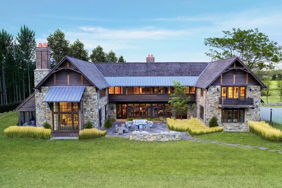 Stone-and-timber country house across a broad lawn